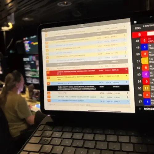 Talk show production software showing a multi-camera rundown on a laptop in a live studio gallery, supporting a seamless current affairs production workflow